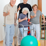 Group of people using various mobility devices giving a thumbs up