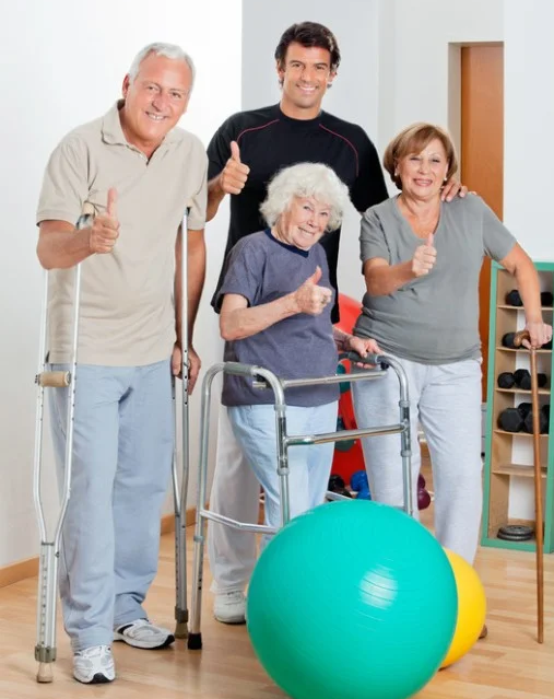 Group of people using various mobility devices giving a thumbs up